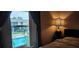Bedroom with window view of the pool and green space at 200 Maitland Ave # 232, Altamonte Springs, FL 32701