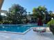 Community pool with lounge area, tables with umbrellas, and a serene atmosphere for outdoor enjoyment at 200 Maitland Ave # 232, Altamonte Springs, FL 32701