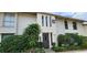 Condo exterior with lush landscaping, mature trees and black trimmed windows at 200 Maitland Ave # 232, Altamonte Springs, FL 32701