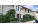 Condo exterior with lush landscaping, mature trees and black trimmed windows at 200 Maitland Ave # 232, Altamonte Springs, FL 32701