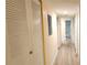 A hallway featuring laminate floors, access to the bathroom, and a closet for additional storage at 200 Maitland Ave # 232, Altamonte Springs, FL 32701
