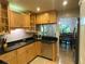 Well-lit kitchen features wood cabinets, stainless steel appliances, and black granite countertops at 200 Maitland Ave # 232, Altamonte Springs, FL 32701
