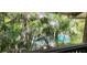 Tropical greenery provides a view of the sparkling community pool at 200 Maitland Ave # 232, Altamonte Springs, FL 32701
