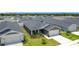 Aerial view of a gray single-story home with front-facing garage and manicured lawn at 2005 Noble Dr, Davenport, FL 33837