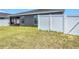 Backyard featuring a screened in patio, enclosed by a white vinyl fence for added privacy and security at 2005 Noble Dr, Davenport, FL 33837