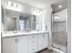Bathroom featuring a glass door shower and a dual sink vanity with counterspace at 2005 Noble Dr, Davenport, FL 33837
