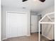 Neutral toned bedroom featuring a closet, ceiling fan, a door, and gray carpeting at 2005 Noble Dr, Davenport, FL 33837