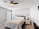 Bright bedroom features a ceiling fan, carpet, and stylish furnishings at 2005 Noble Dr, Davenport, FL 33837