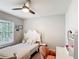 Bedroom featuring a bed, window, ceiling fan, a vanity and chair, and gray carpeting at 2005 Noble Dr, Davenport, FL 33837
