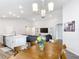 Spacious dining area with modern lighting that connects to the kitchen and living room, perfect for entertaining at 2005 Noble Dr, Davenport, FL 33837