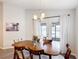 Bright dining room featuring an elegant wood table, chandelier, and sliding glass doors to the outdoor patio at 2005 Noble Dr, Davenport, FL 33837