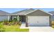 Charming single-story home featuring a two-car garage and beautifully landscaped front yard at 2005 Noble Dr, Davenport, FL 33837