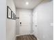 Inviting foyer featuring a front door, hardwood floors, and stylish wall decor at 2005 Noble Dr, Davenport, FL 33837