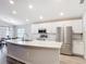 Bright, open kitchen featuring stainless steel appliances and a spacious island with marble countertops at 2005 Noble Dr, Davenport, FL 33837