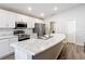 Modern kitchen featuring a spacious island, stainless steel appliances, and white cabinets for a clean, sleek look at 2005 Noble Dr, Davenport, FL 33837