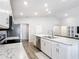 Open-concept kitchen with a large island, stainless steel appliances, and ample storage space at 2005 Noble Dr, Davenport, FL 33837