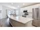 Bright kitchen with white cabinets, stainless steel appliances, and an island for ample counter space and meal prep at 2005 Noble Dr, Davenport, FL 33837