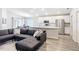 Open-concept living area with a modern kitchen, breakfast bar, and a comfy sectional sofa at 2005 Noble Dr, Davenport, FL 33837