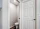 Toilet room features a toilet and a door, conveniently located near a walkway at 2005 Noble Dr, Davenport, FL 33837