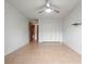 A spacious bedroom featuring tile flooring, neutral walls, and a ceiling fan at 206 Diamond Cv # 106, Casselberry, FL 32707