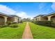 Exterior lawn view of charming home community with manicured lawns and inviting walkways at 206 Diamond Cv # 106, Casselberry, FL 32707