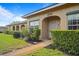 Charming tan home exterior with well-maintained landscaping and an inviting arched entryway at 206 Diamond Cv # 106, Casselberry, FL 32707