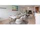 Open-concept living and dining area with modern furnishings and serene beach-themed artwork at 206 Diamond Cv # 106, Casselberry, FL 32707