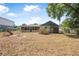 Backyard featuring mature shade trees, a screened porch, storage shed, and a swing set, offering various outdoor amenities at 2106 Altoona Ln, Deltona, FL 32738