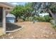 Spacious backyard featuring a swing set, storage shed, mature trees, and ample space for outdoor activities at 2106 Altoona Ln, Deltona, FL 32738