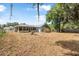 Wide backyard with a screened porch, swing set, and a storage shed with mature shade trees overhead at 2106 Altoona Ln, Deltona, FL 32738