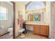 Bathroom featuring toilet, a vanity with lighted mirror, and tile floors and baseboards at 2106 Altoona Ln, Deltona, FL 32738