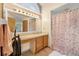 Bathroom featuring floral shower curtain, vanity with mirror, and a lighted vanity with a unique half moon window above at 2106 Altoona Ln, Deltona, FL 32738
