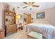 Bedroom featuring neutral walls, ceiling fan and built in shelving with decorations at 2106 Altoona Ln, Deltona, FL 32738