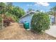 View of the side of the house, green trash can, and flowering plants creating a welcoming outdoor space at 2106 Altoona Ln, Deltona, FL 32738