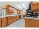 Traditional kitchen with wood cabinets, tile backsplash and light tile floors at 2106 Altoona Ln, Deltona, FL 32738
