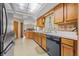 Bright kitchen features light countertops, wood cabinets and view to living area at 2106 Altoona Ln, Deltona, FL 32738