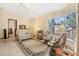 Inviting living room featuring tile floors, comfortable seating, and bright bay windows at 2106 Altoona Ln, Deltona, FL 32738