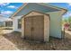 Durable outdoor storage shed provides ample space for all your equipment, set against the house at 2106 Altoona Ln, Deltona, FL 32738