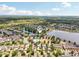 Aerial view of a community featuring lakes, a pool, and neatly arranged homes with green spaces at 2116 Truffle Ln, Casselberry, FL 32707