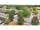 An aerial view of a home in a neighborhood near a lake surrounded by mature trees and sidewalks at 2116 Truffle Ln, Casselberry, FL 32707