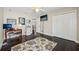 Bedroom area with dark wood floors, patterned rug, a desk area, and double closets at 2116 Truffle Ln, Casselberry, FL 32707