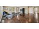 Spacious exercise room with wood floors, ample natural light, and fitness equipment at 2116 Truffle Ln, Casselberry, FL 32707