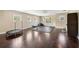 Spacious exercise room with wood floors, ample natural light, and fitness equipment at 2116 Truffle Ln, Casselberry, FL 32707