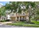 Street view featuring a two-story home with a large front porch and attached garage at 2116 Truffle Ln, Casselberry, FL 32707