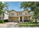 Charming two-story home with a well-manicured lawn, spacious driveway, and welcoming front porch at 2116 Truffle Ln, Casselberry, FL 32707