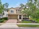Beautiful two-story home featuring a manicured lawn, front porch and attached two-car garage at 2116 Truffle Ln, Casselberry, FL 32707