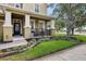 Inviting front porch with decorative railing, manicured landscaping, and a charming entrance to the home at 2116 Truffle Ln, Casselberry, FL 32707
