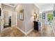 Inviting hallway with tile flooring, decorative mirror, and hallway table with lamps at 2116 Truffle Ln, Casselberry, FL 32707