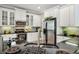 Bright kitchen with updated appliances, stainless steel refrigerator, and marble countertops at 2116 Truffle Ln, Casselberry, FL 32707