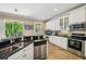 Beautiful kitchen featuring stainless steel dishwasher and appliances, marble countertops at 2116 Truffle Ln, Casselberry, FL 32707